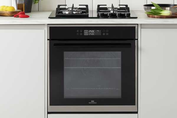 A New World built-in single electric oven with a gas hob in a kitchen.